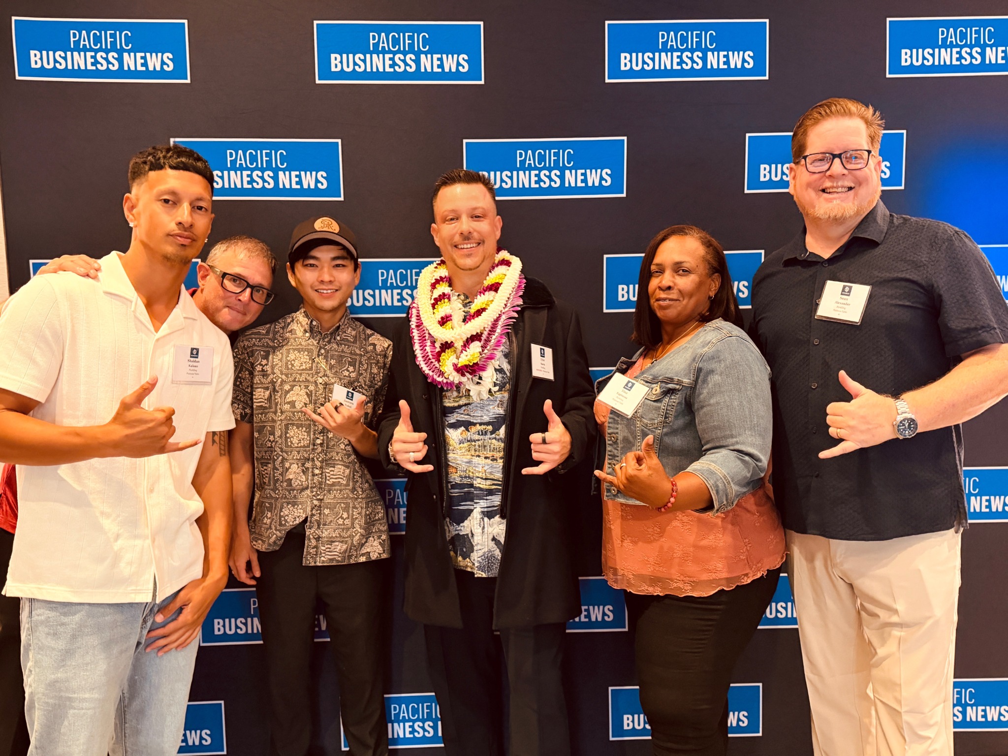 Tyler Saenz wearing lei with the PARKLINQ team at the 2026 Pacific Business News celebration